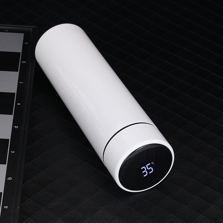 White thermos with digital temperature display on a black grid background